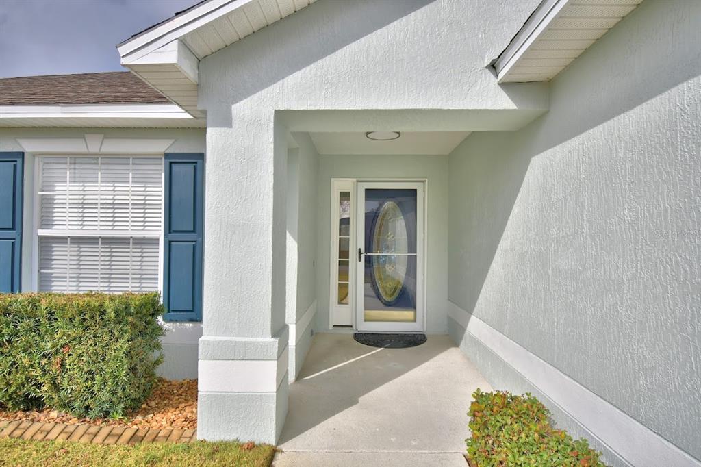 A single-story house with a light-colored exterior, a two-car garage, and a front lawn — 511 HEATHER GLEN DRIVE, WINTER HAVEN, FL
