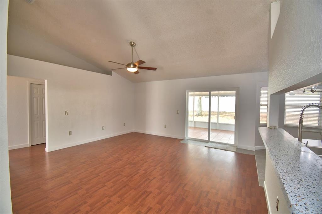 An entryway features a white front door with a decorative oval glass insert and tile flooring — 511 HEATHER GLEN DRIVE, WINTER HAVEN, FL
