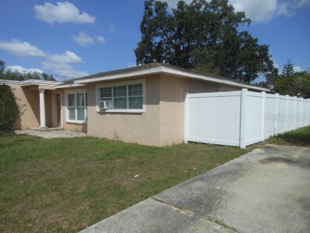 A single-story house with a white vinyl fence and a concrete driveway — 2925 W PARIS STREET, TAMPA, FL