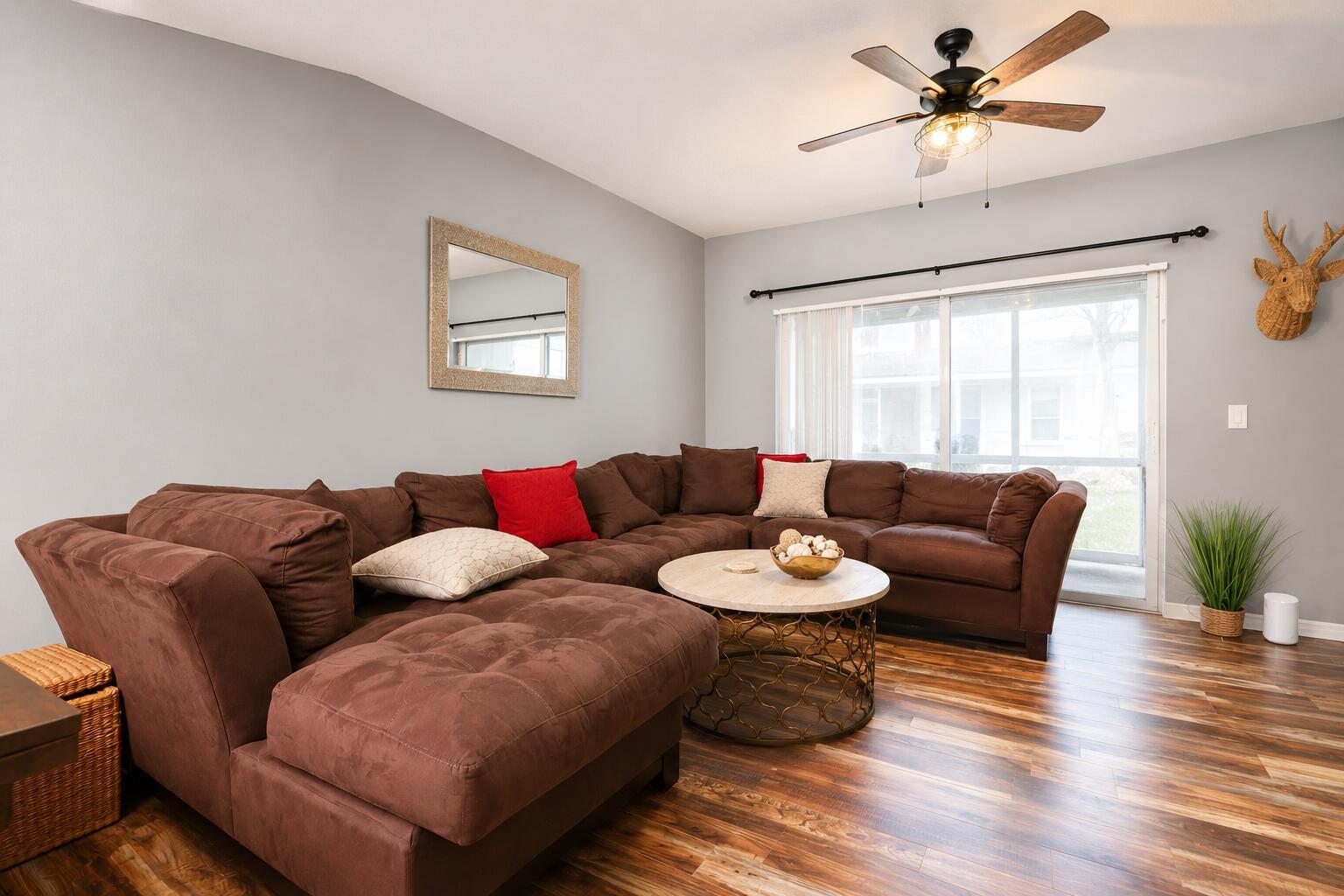 A living room features a brown sectional sofa, a round coffee table, and wood-look flooring — 3314 Concert Lane # 128, Margate FL 33063, MARGATE, FL