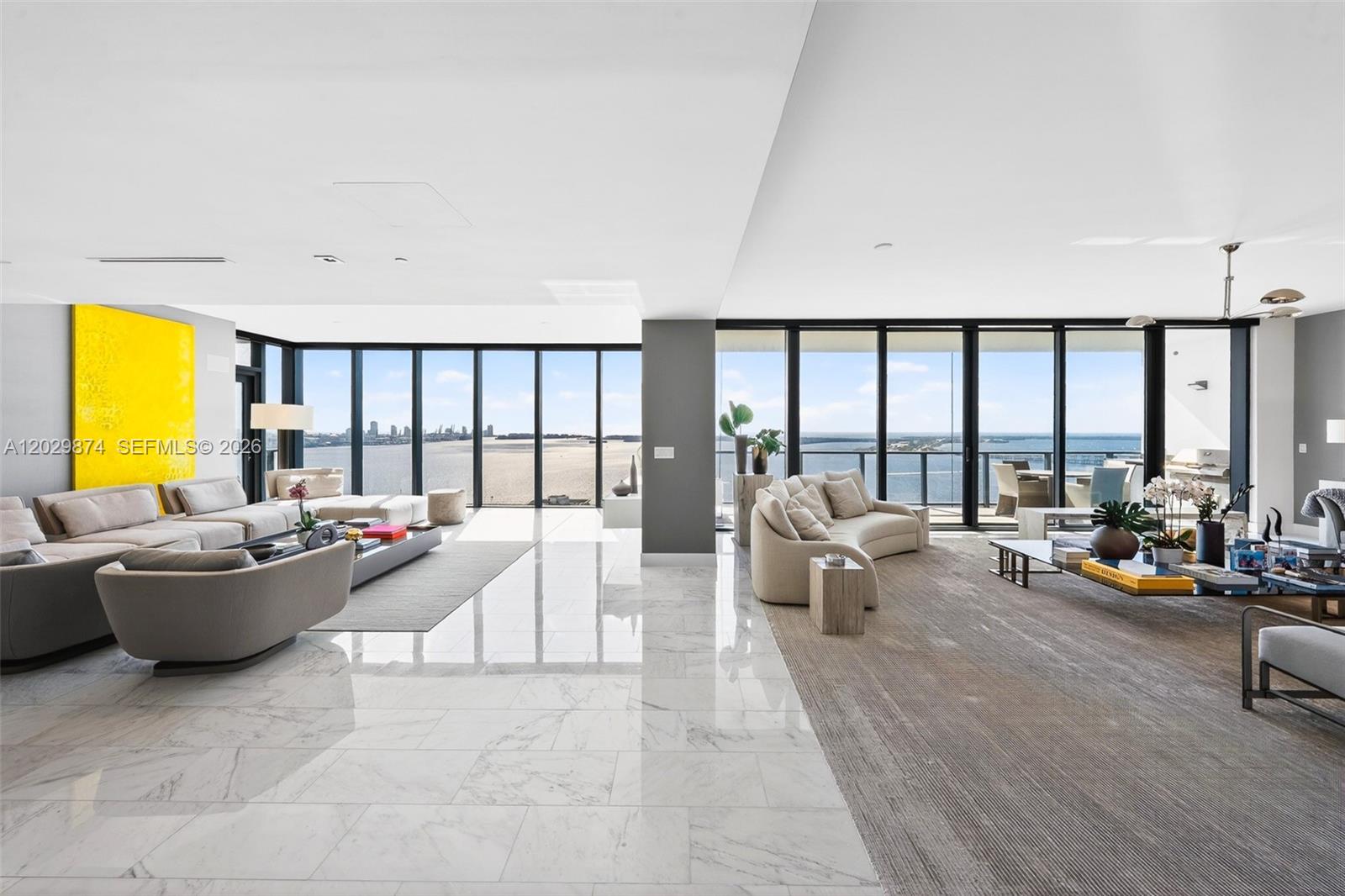 A spacious living room features marble floors, floor-to-ceiling windows, and panoramic ocean views — 1451 Brickell Ave # 2901, Miami FL 33131, MIAMI, FL