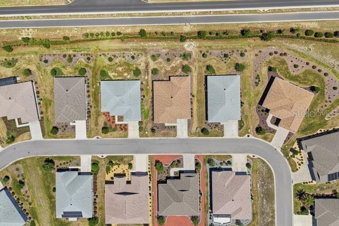 An aerial view shows a suburban neighborhood with several houses, driveways, and a curved street — 8907 SW 104TH CIRCLE, OCALA, FL