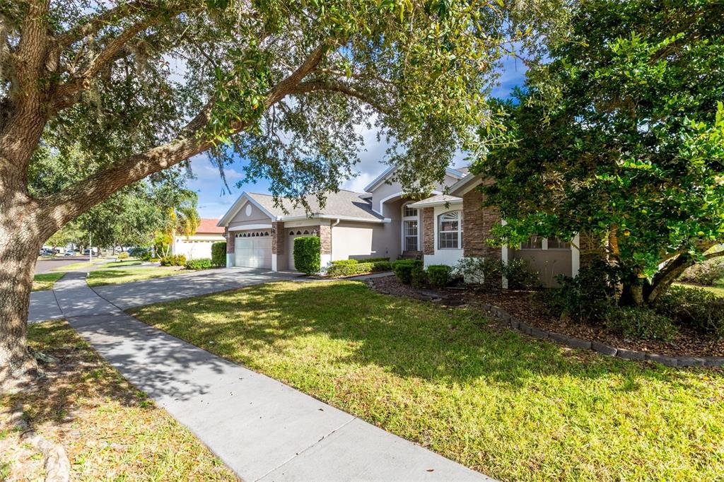 A single-story suburban house with a stone facade, a two-car garage, and a concrete driveway — 13157 PALOMA DRIVE, ORLANDO, FL
