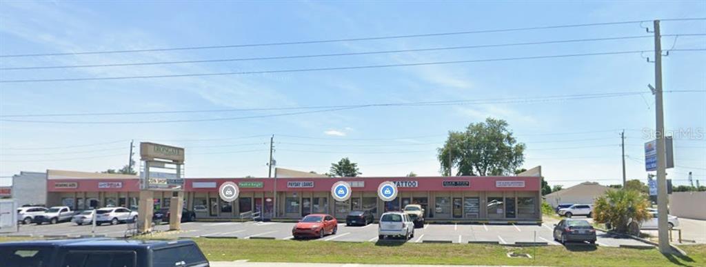 A single-story commercial strip mall with multiple storefronts and a parking lot in front — 2205 TAMIAMI TRAIL UNIT I, PORT CHARLOTTE, FL