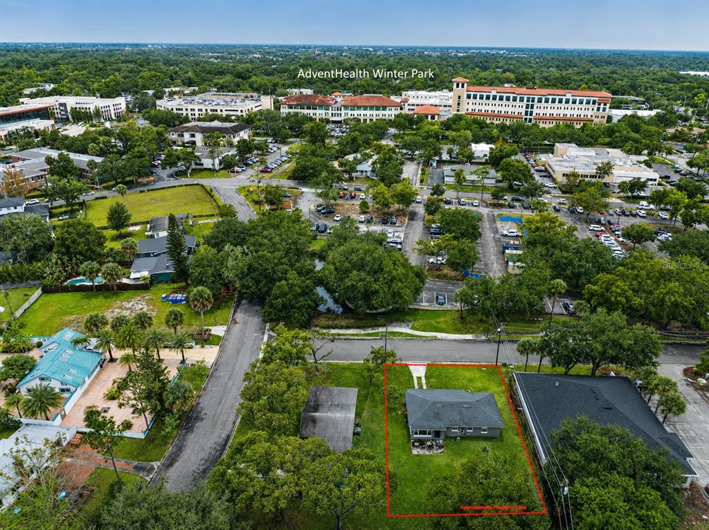 An aerial view shows a residential lot with a house outlined in red near a hospital — 230 STRATHY LANE, WINTER PARK, FL