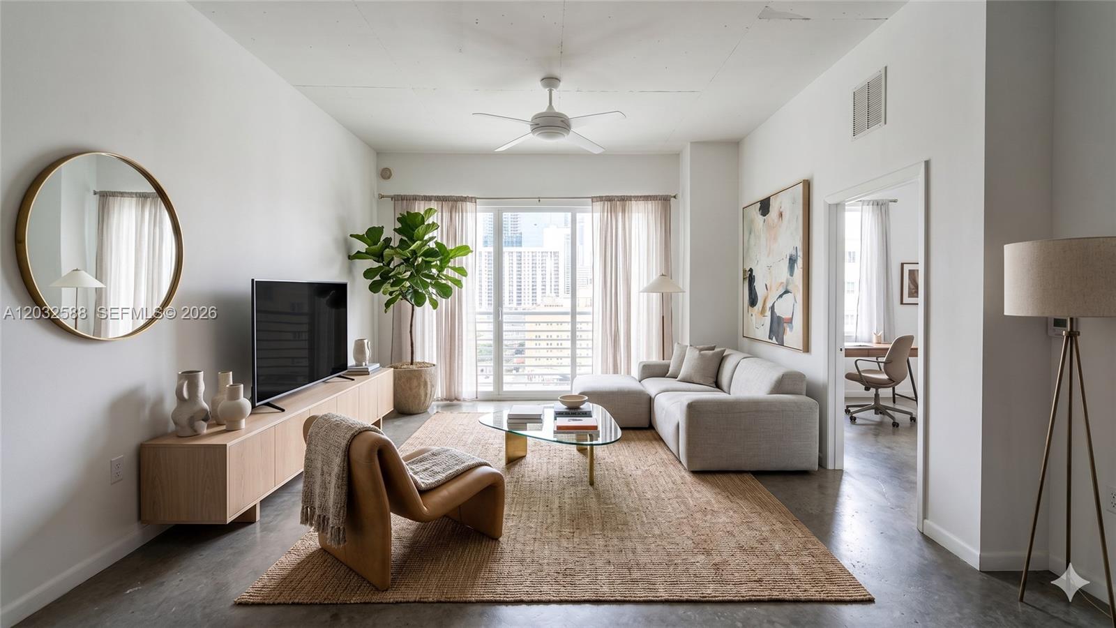 A modern living room features a sectional sofa, a leather chair, and a glass coffee table — 133 NE 2nd Ave # 1906, Miami FL 33132, MIAMI, FL