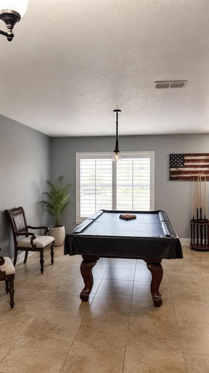 A game room features a pool table, a potted plant, and a wooden American flag — 1042 HORSESHOE FALLS DRIVE, ORLANDO, FL