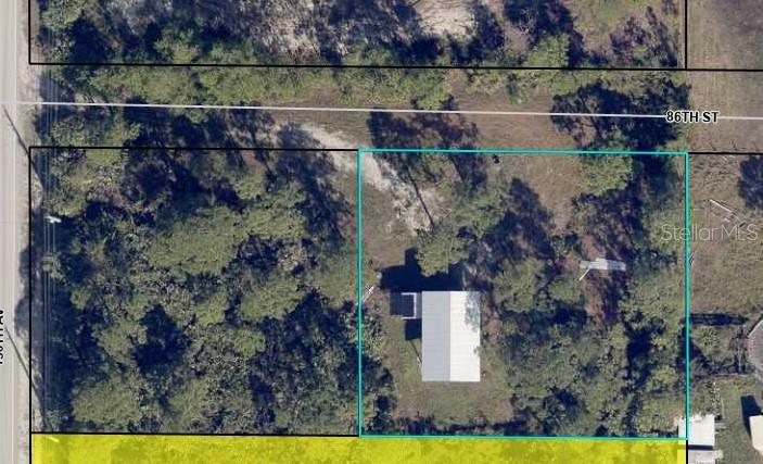 This aerial map view shows a rectangular property lot containing a house with a metal roof — 12885 86TH STREET, FELLSMERE, FL