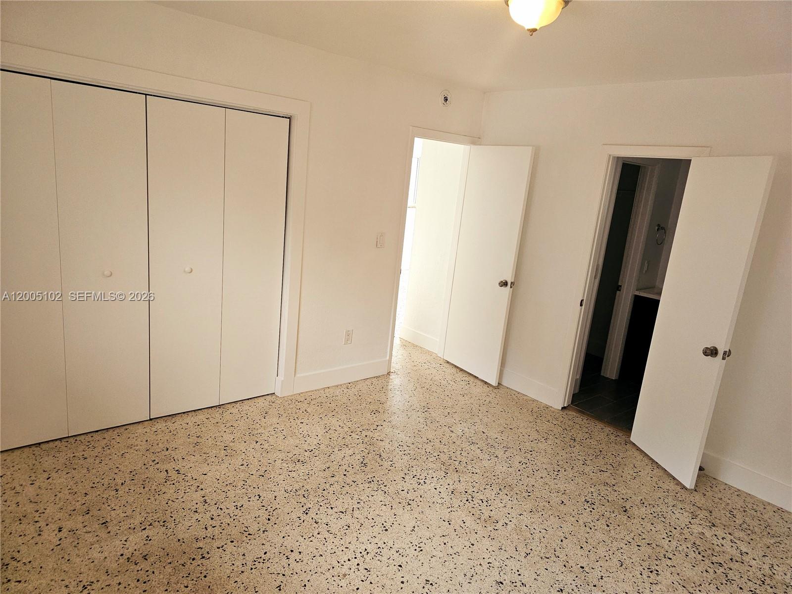 A bedroom features white walls, a large closet, and speckled terrazzo flooring — 1736 SW 3rd St # 3, Miami FL 33135, MIAMI, FL
