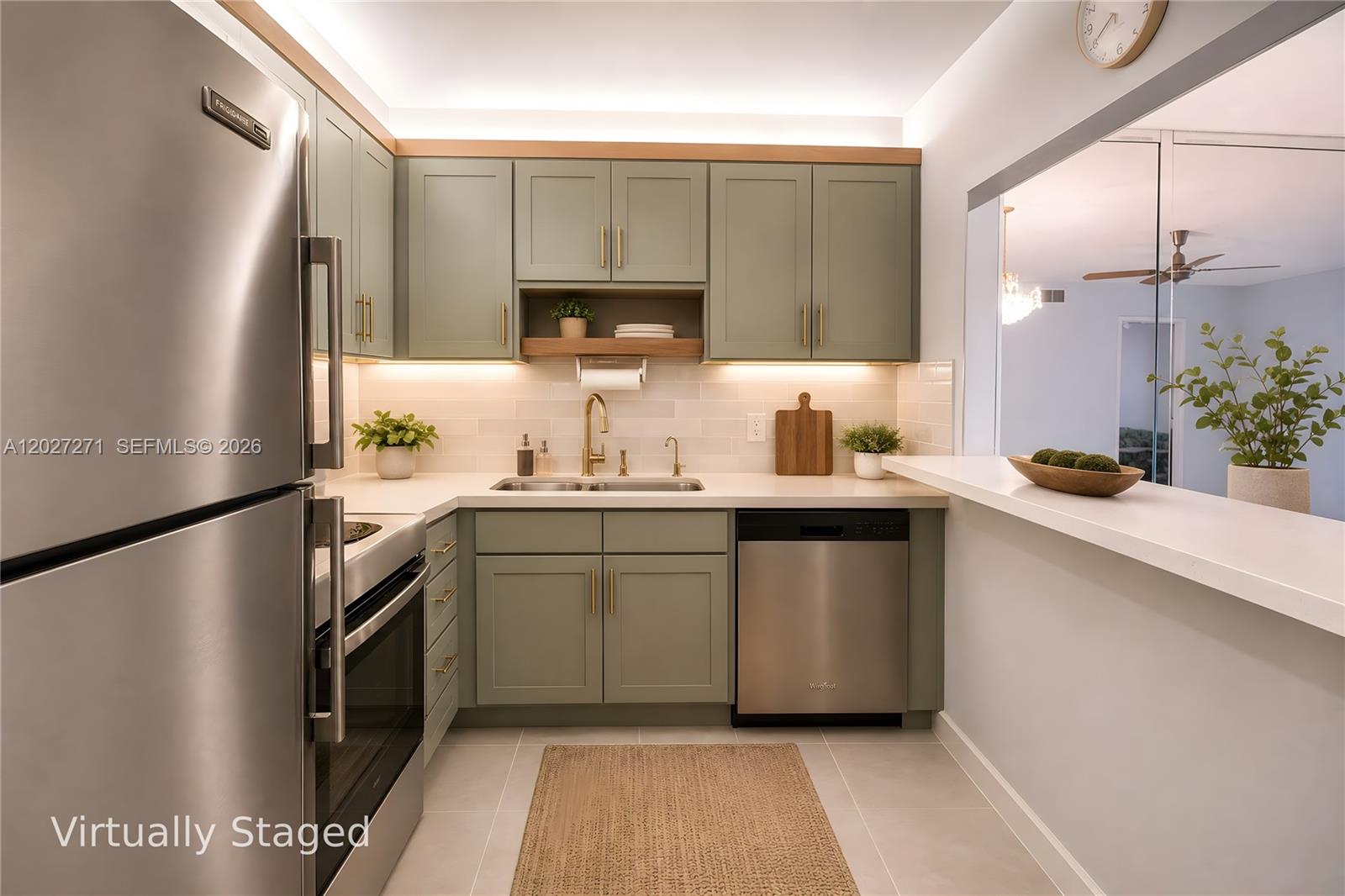 A kitchen features sage green cabinets, stainless steel appliances, and a white countertop — 5621 SW 2nd Ct # 101, Margate FL 33068, MARGATE, FL