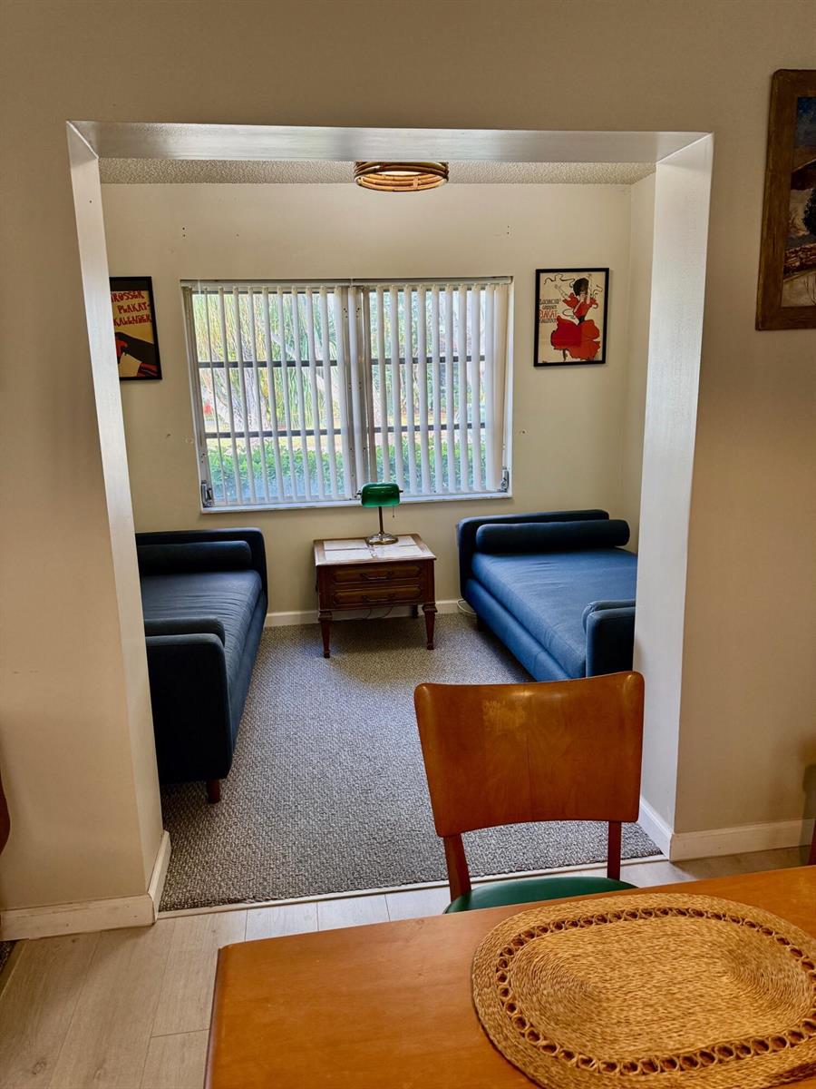 A small room features two blue daybeds flanking a wooden side table under a window — 14464 Campanelli Drive, Delray Beach FL 33484, DELRAY BEACH, FL