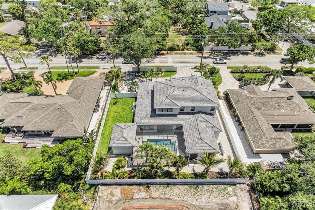 An aerial view shows a modern house with a tiled roof, pool, and fenced yard — 1516 S ORANGE AVENUE, SARASOTA, FL