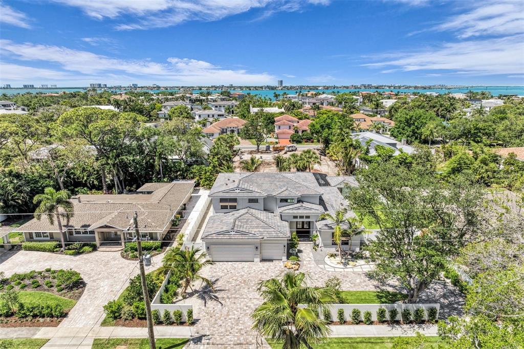 An aerial view shows a modern two-story house with a large paved driveway and landscaping — 1516 S ORANGE AVENUE, SARASOTA, FL