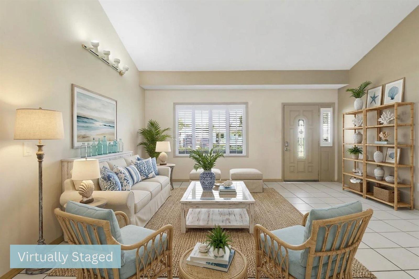 This virtually staged living room features a vaulted ceiling, tile flooring, and coastal-style furniture — 5601 Palm Drive, Fort Pierce FL 34982, FORT PIERCE, FL