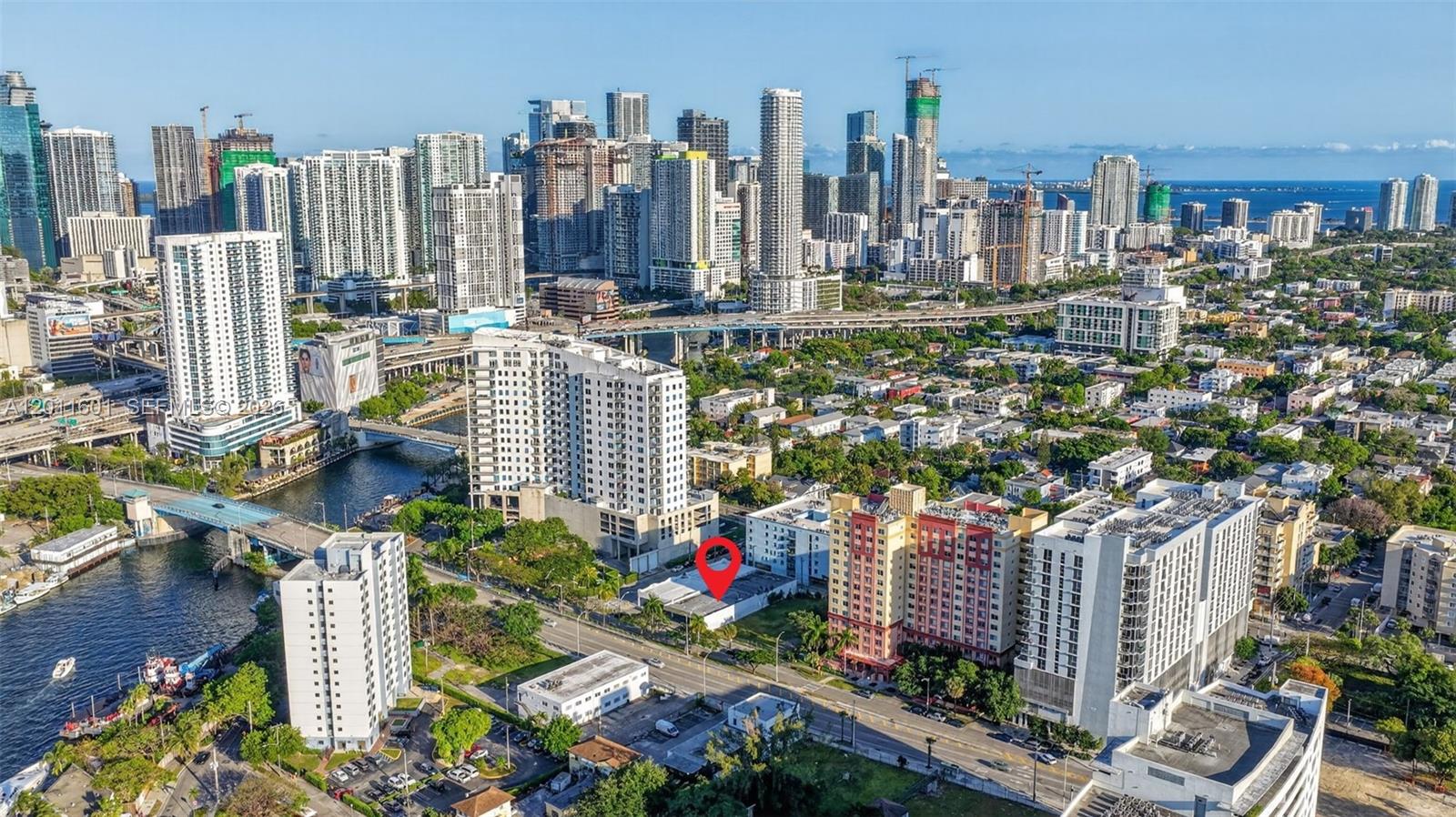 An aerial view of a city skyline with a red pin marking a low-rise building — 500 W Flagler St, Miami FL 33130, MIAMI, FL