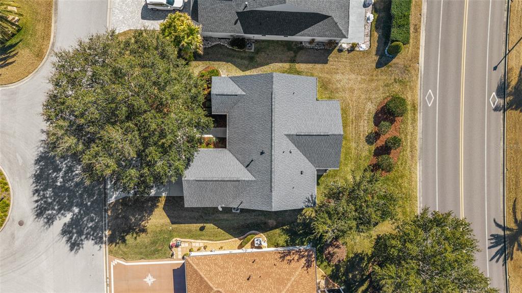 An aerial view shows a house with a gray shingled roof and a large tree — 8337 SE 176TH LAWSON LOOP, THE VILLAGES, FL