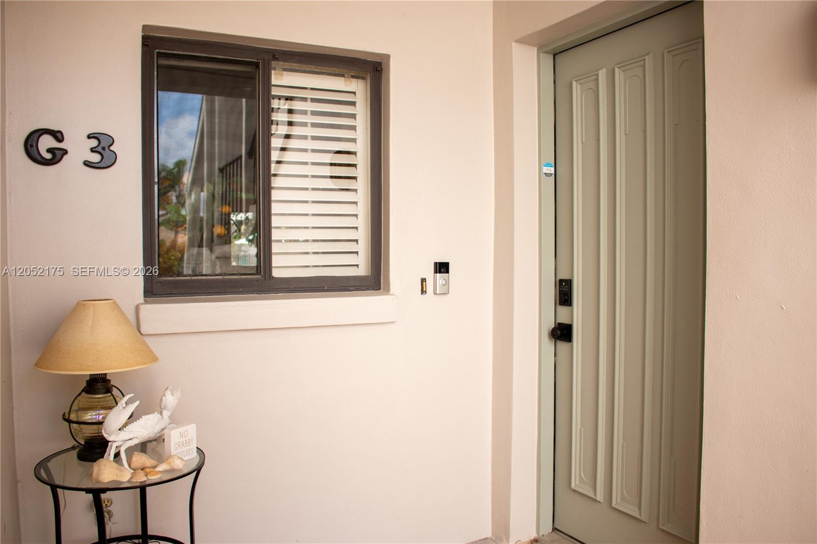 A light-colored exterior entryway features a window labeled G3, a door, and a small table — VERO BEACH, FL