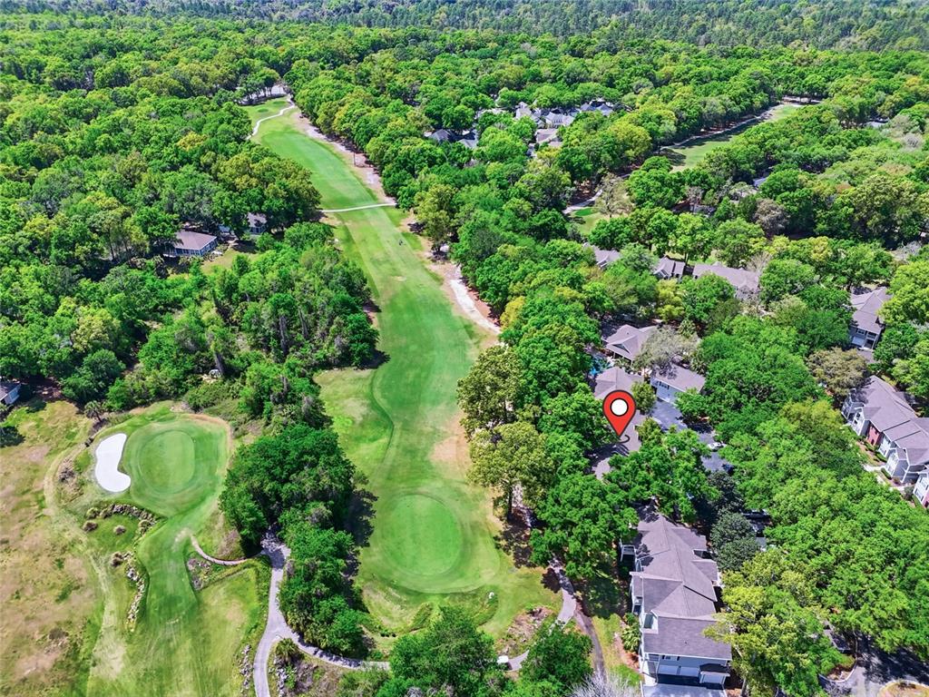 An aerial view shows a residential property marked with a pin next to a golf course — 10000 SW 52ND AVENUE UNIT B6, GAINESVILLE, FL