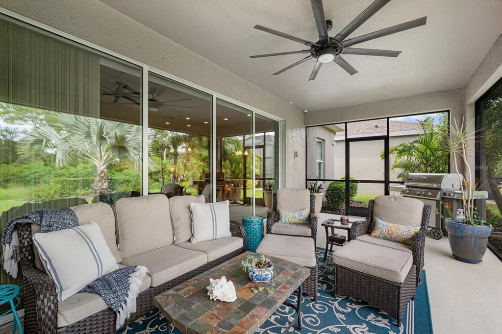 A kitchen features wood cabinets, granite countertops, a large island, and tile flooring — 6502 MAIDEN SEA DRIVE, APOLLO BEACH, FL