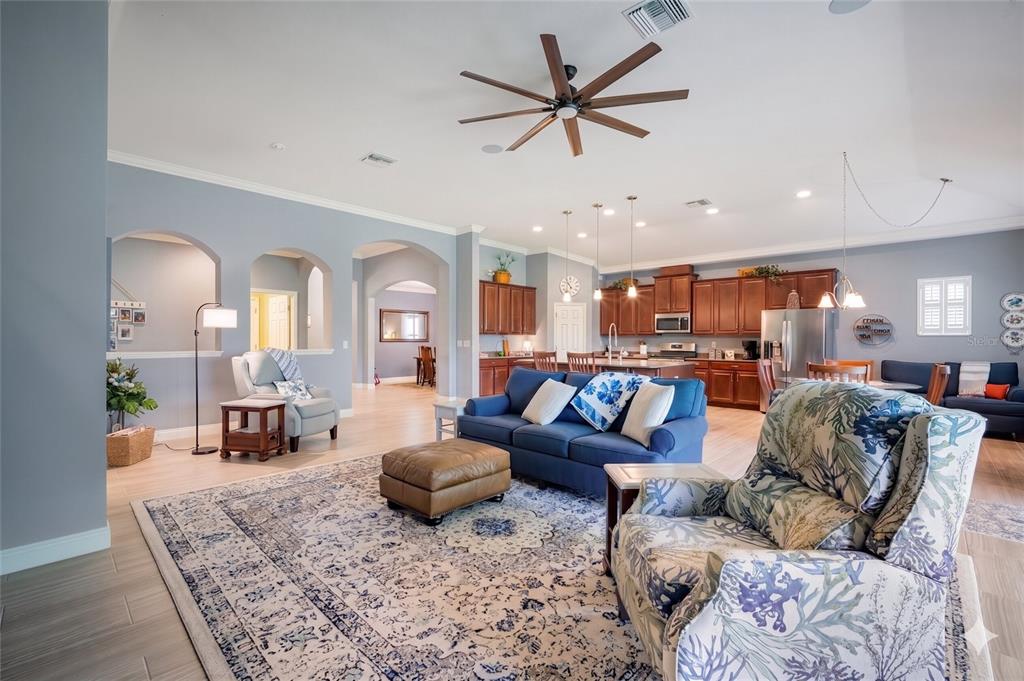 A kitchen island with a granite countertop and stainless steel dishwasher faces a dining area — 6502 MAIDEN SEA DRIVE, APOLLO BEACH, FL
