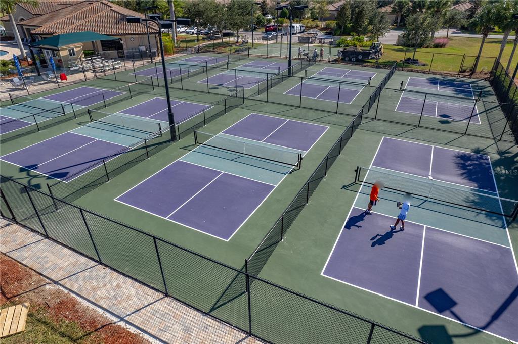 An aerial view of multiple pickleball courts with purple playing surfaces and surrounding chain-link fencing — 6411 GRAND ESTUARY TRAIL UNIT 401, BRADENTON, FL