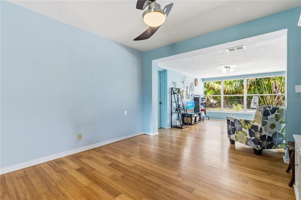 A dining room features a marble-topped table, gray upholstered chairs, and light blue walls — 1508 ERIN LANE, CLEARWATER, FL