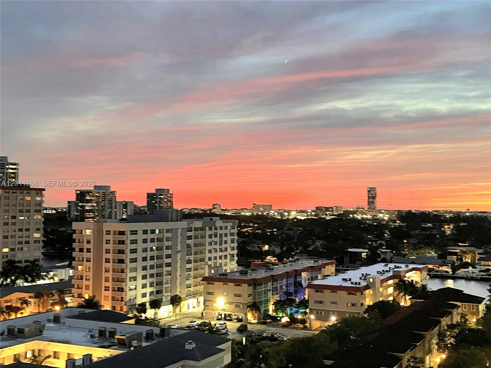 An elevated view of a city skyline at sunset with residential buildings and a waterway — 2030 S Ocean Dr # 1107, Hallandale Beach FL 33009, HALLANDALE BEACH, FL