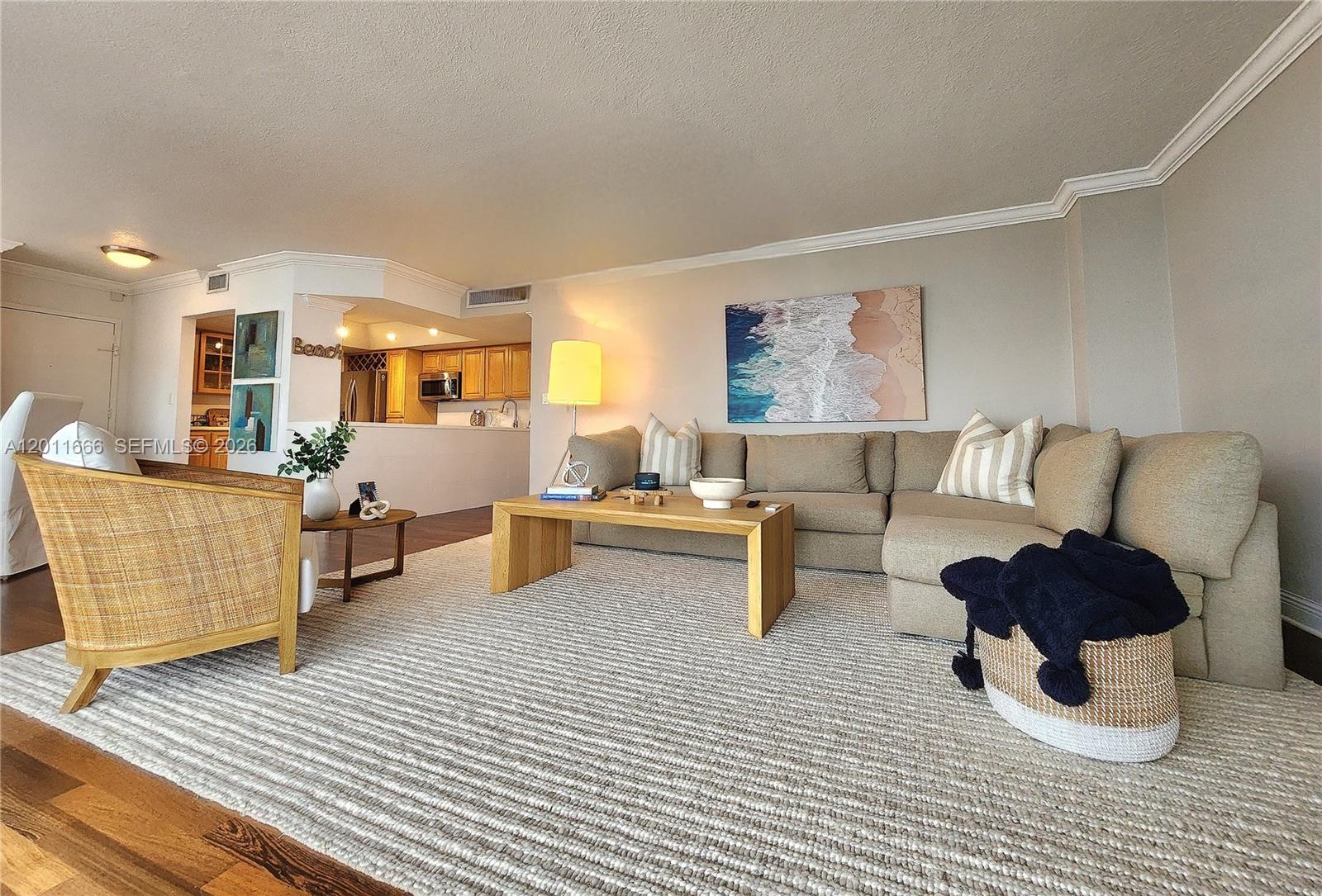 A living room features a beige sectional sofa, a wooden coffee table, and a rug — 2030 S Ocean Dr # 1107, Hallandale Beach FL 33009, HALLANDALE BEACH, FL