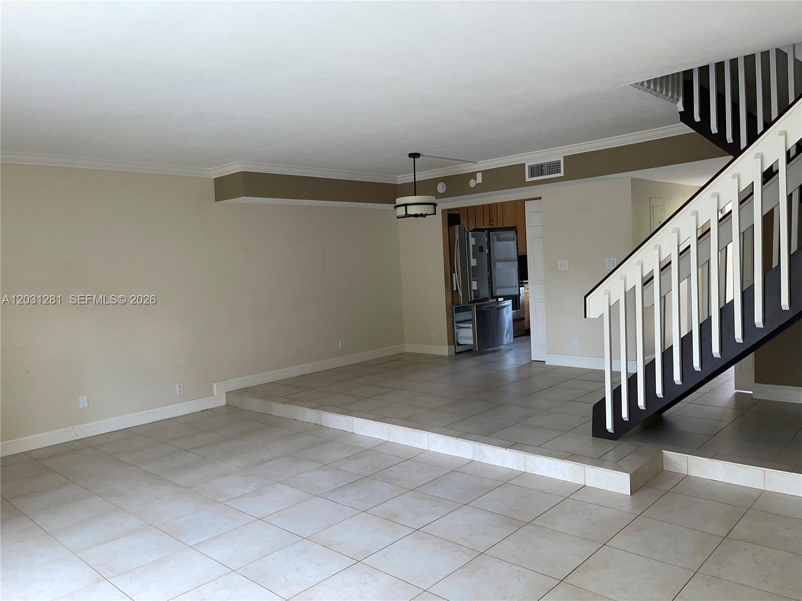 An interior view shows a living area with a sunken floor and a staircase — 7175 Nova Dr # 507, Davie FL 33317, DAVIE, FL
