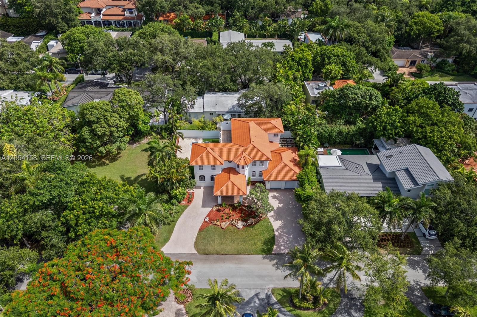 An aerial view shows a two-story house with a terracotta tile roof and driveway — 145 W Sunrise Ave, Coral Gables FL 33133, CORAL GABLES, FL