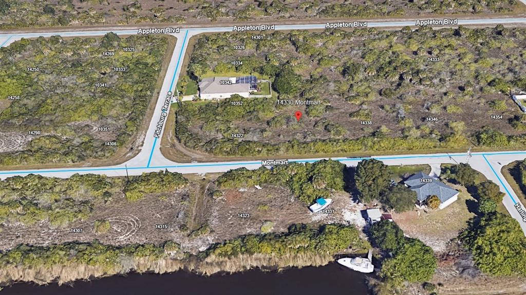 This is an aerial map view of a residential neighborhood with vacant lots and houses — 14330 MONTMARTE AVENUE, PORT CHARLOTTE, FL