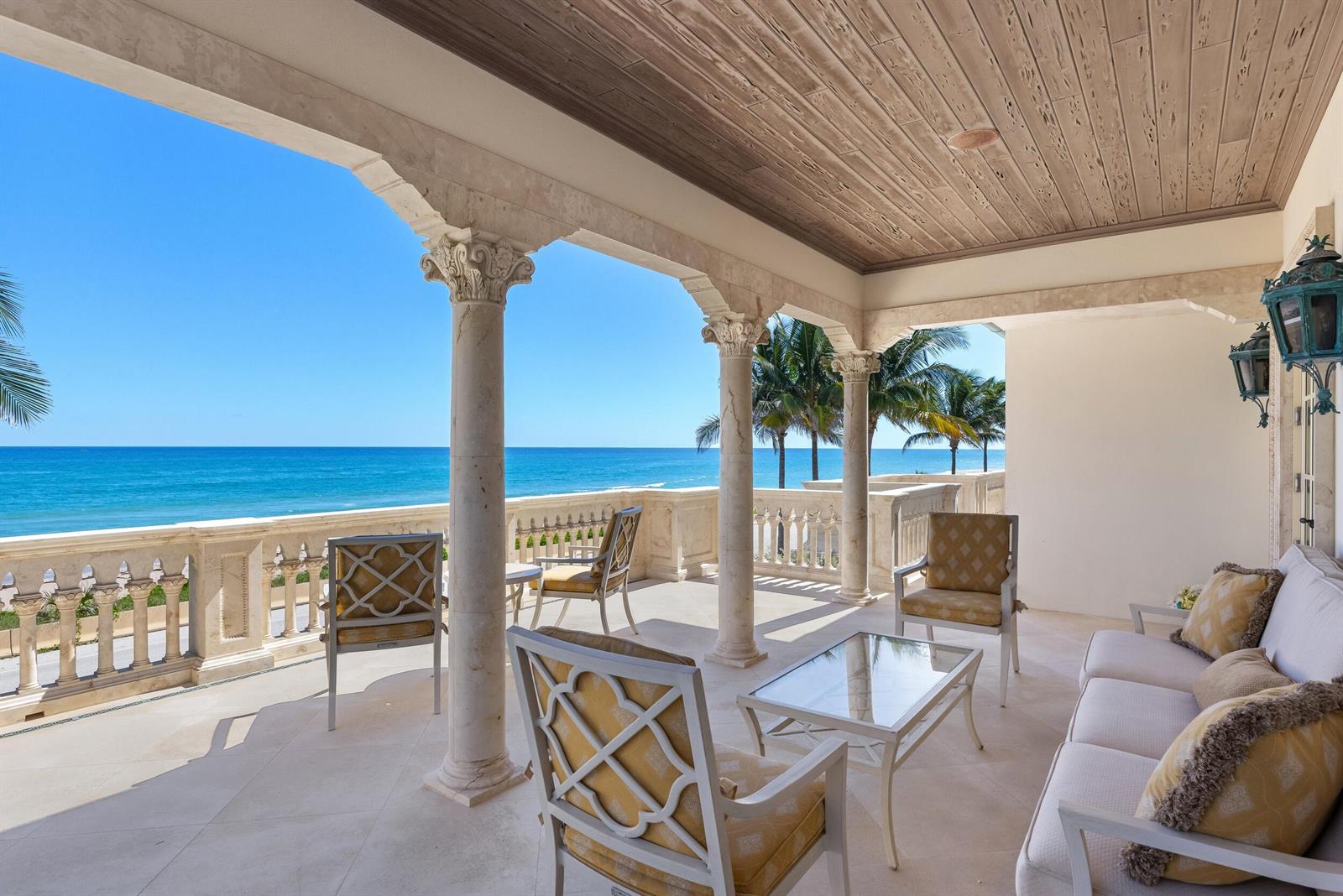 A covered stone terrace with columns overlooks the ocean and features outdoor seating furniture — 1620 S Ocean Boulevard, Palm Beach FL 33480, PALM BEACH, FL