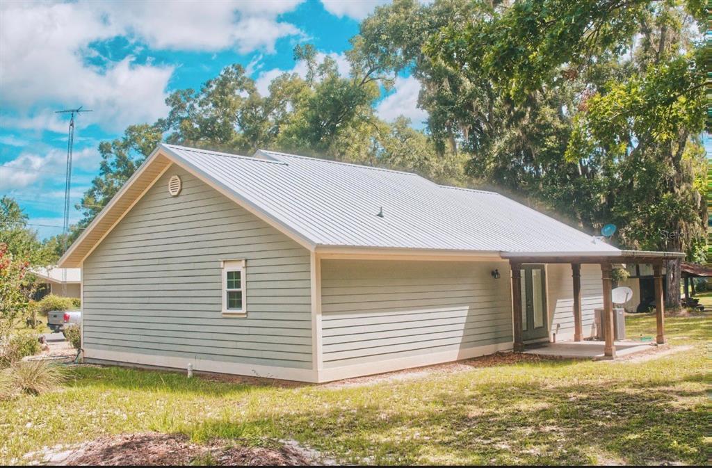 A light green house with a metal roof and a small covered porch — 3109 E BRYANT AVENUE, BELL, FL