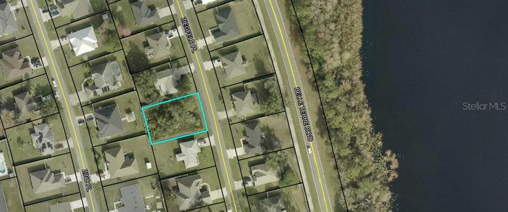 This is an aerial map view of a vacant residential lot outlined in blue — 10 ZIEGFELD PLACE, PALM COAST, FL