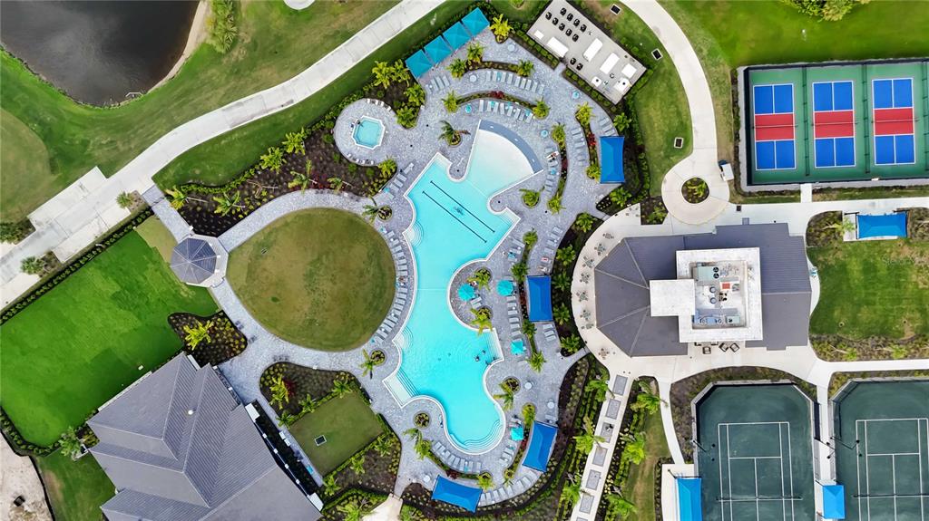An aerial view shows a community pool, tennis courts, and clubhouse facilities — 17475 OPAL SAND DRIVE UNIT 207, VENICE, FL