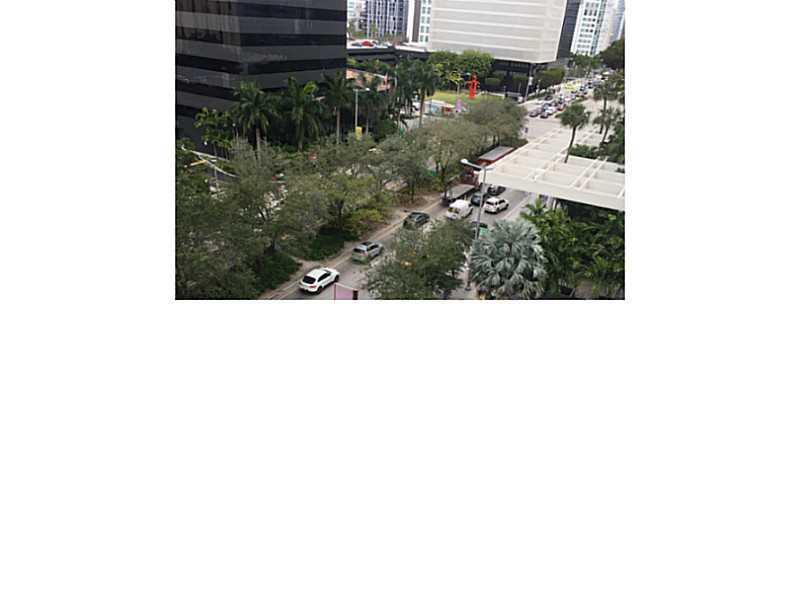An elevated view of a city street lined with trees and modern office buildings — 951 Brickell Avenue # 701, Miami FL 33131, MIAMI, FL