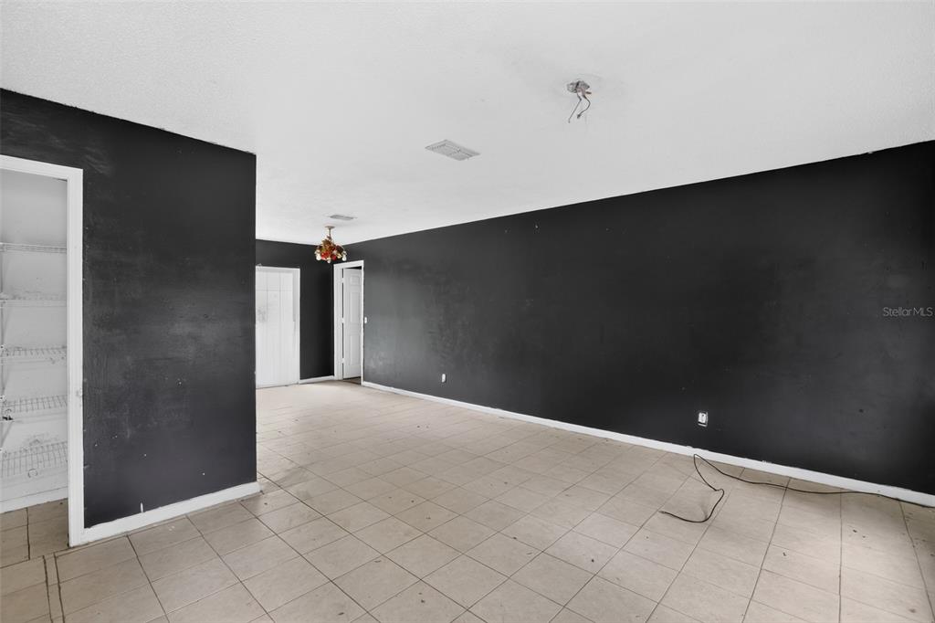 An empty room features black walls, white trim, and light-colored tile flooring — 5179 MARCUS DRIVE, GREENWOOD, FL