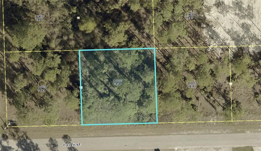 An aerial map view shows a rectangular parcel of land outlined in blue along a road — 1103 E 11TH STREET, LEHIGH ACRES, FL