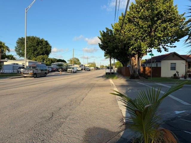 A street view shows a road, parked vehicles, a large tree, and a residential house — 890 E 52nd St, Hialeah FL 33013, HIALEAH, FL