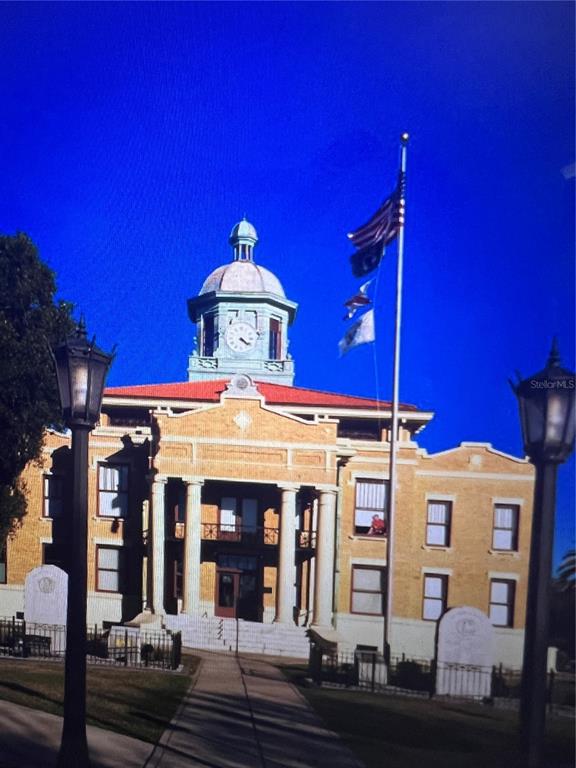A historic brick courthouse building features a central clock tower and a tall flagpole — 6390 E MORLEY STREET, INVERNESS, FL