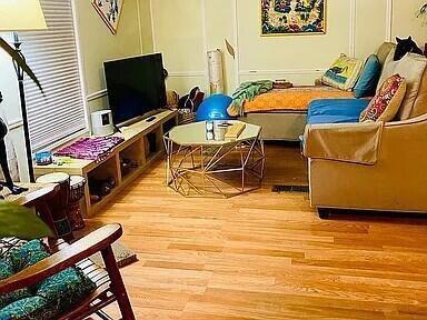 A living room features a television on a wooden stand, a sofa, and hardwood floors — 1361 Overseas Highway # G5, Marathon FL 33050, MARATHON, FL