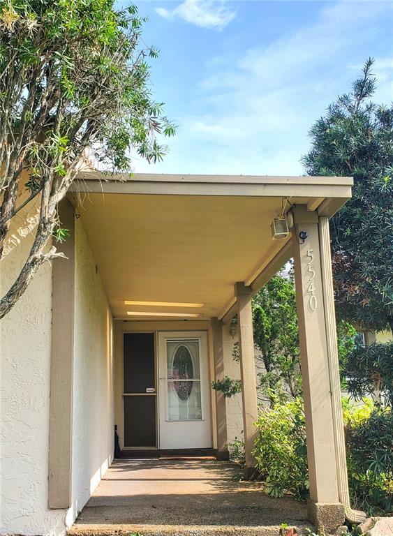 A covered front porch leads to a white front door with an oval glass insert — 5540 MINUTE MAN COURT, ORLANDO, FL