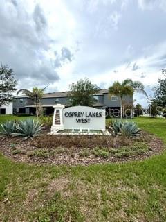 A sign for Osprey Lakes West stands in front of a multi-story apartment building — 8771 FALLING BLUE PLACE, RIVERVIEW, FL