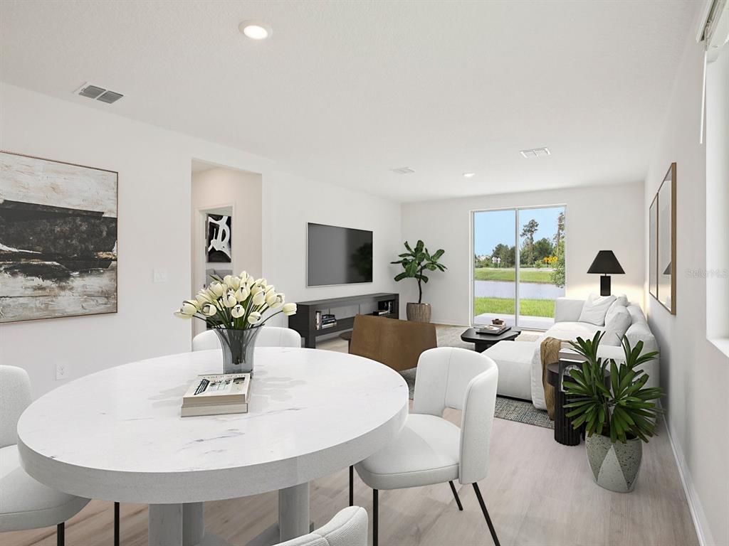 This digital rendering shows a modern open-concept living and dining area with white furniture — 1475 BREKEY WAY, ZEPHYRHILLS, FL