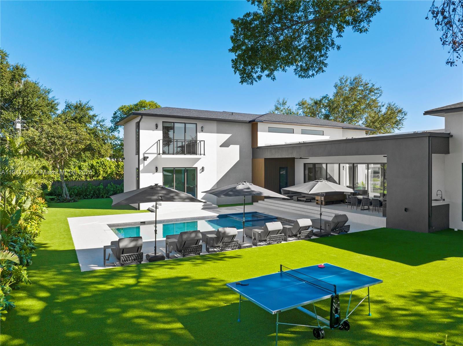 A modern two-story house with a pool, patio, and ping pong table in the backyard — 1881 NE 196th Ter, Miami FL 33179, MIAMI, FL