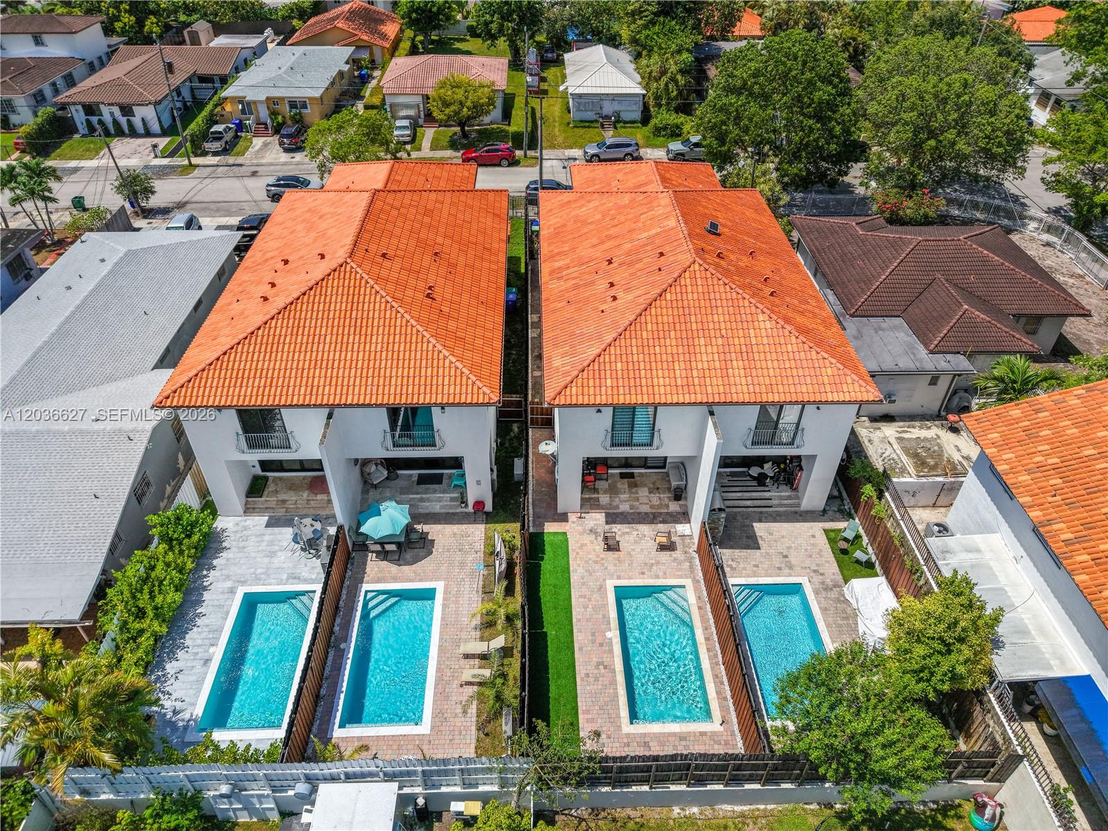 An aerial view shows two adjacent houses with orange tile roofs and private swimming pools — 3022 SW 17th St # 3022, Miami FL 33145, MIAMI, FL