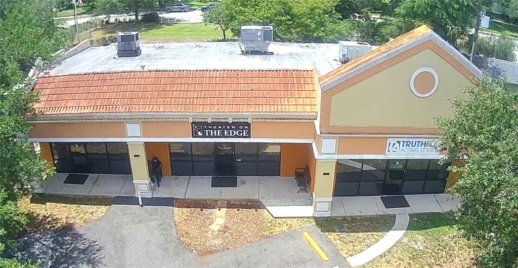 An aerial view of a commercial building with a tiled roof and two storefront entrances — 5544 HANSEL AVENUE UNIT 1, ORLANDO, FL