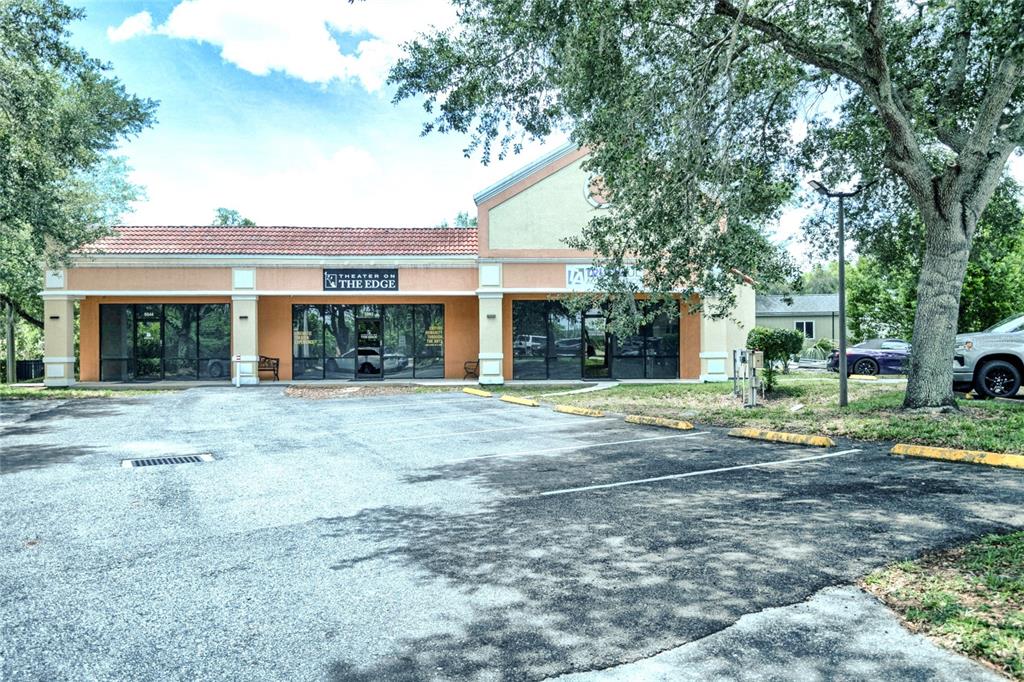 A single-story commercial building with a tiled roof and a parking lot in front — 5544 HANSEL AVENUE UNIT 1, ORLANDO, FL