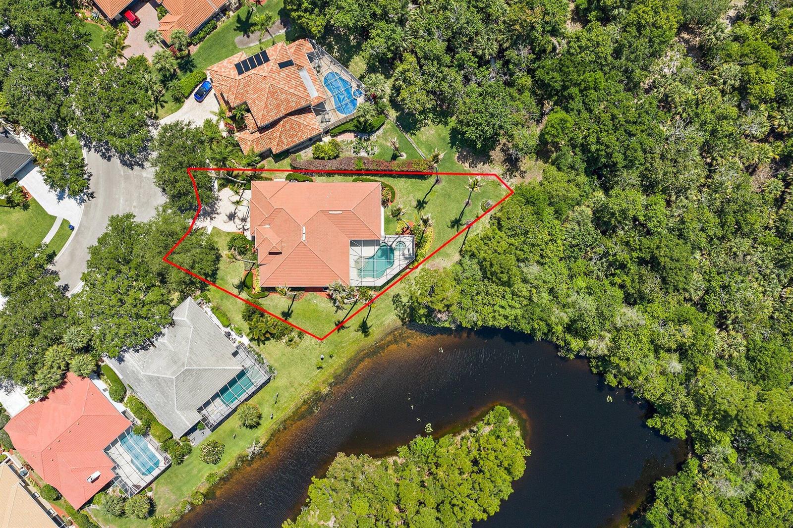 An aerial view shows a house with a pool and red tile roof on a lot — 19189 Tamara Lane, Jupiter FL 33458, JUPITER, FL
