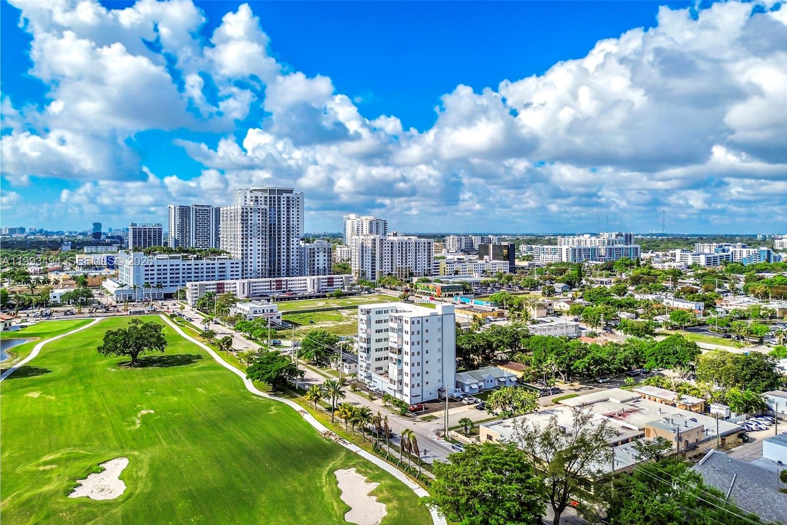 An aerial view shows a golf course adjacent to residential buildings and a city skyline — 1700 Pierce St # 804, Hollywood FL 33020, HOLLYWOOD, FL